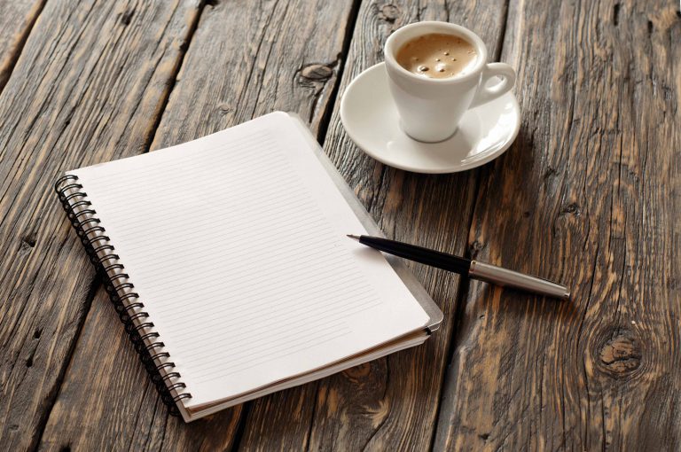 open notebook with blank pages and pen with coffee espresso CPIWorld